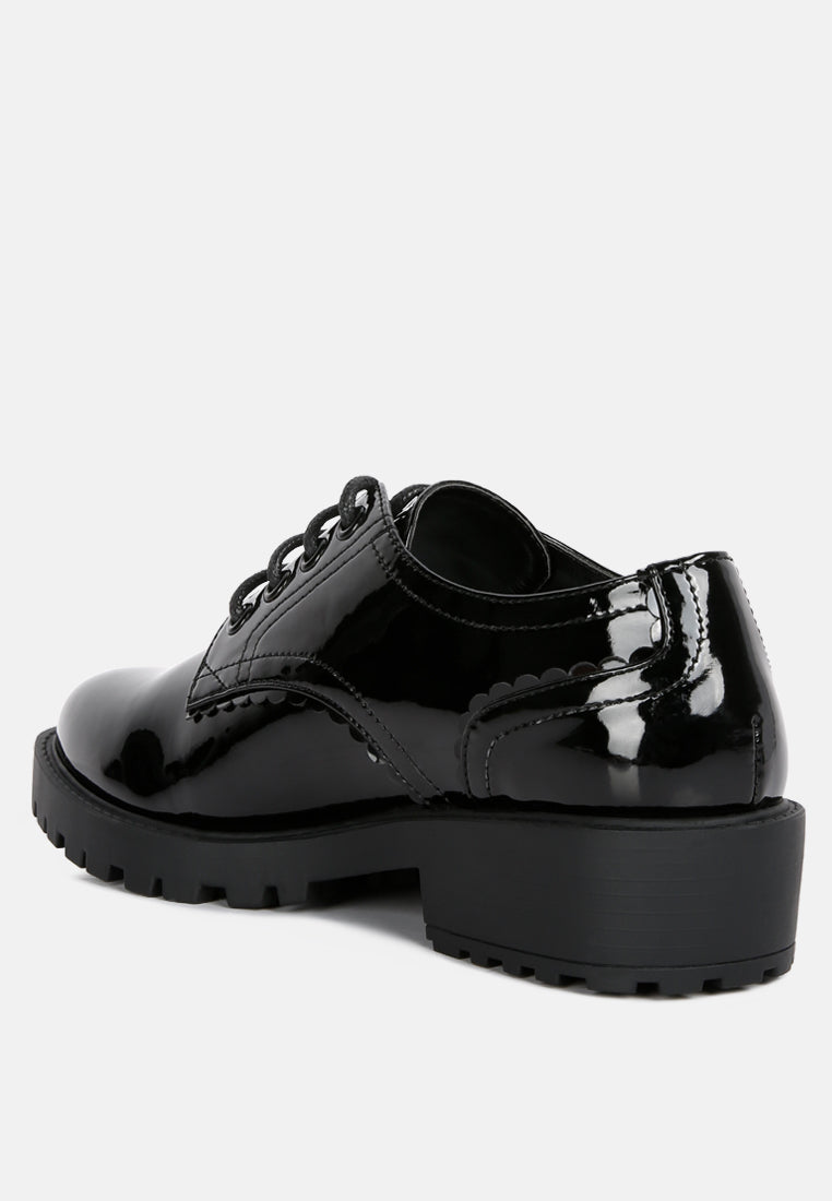 Black patent derby shoes, rear-quarter view with lace eyelets