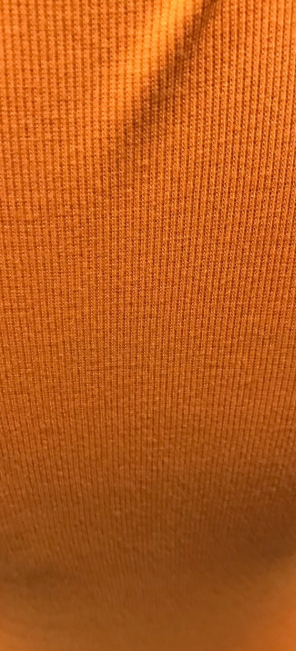 Product listing for an orange long-sleeve V-neck knit top on a website.