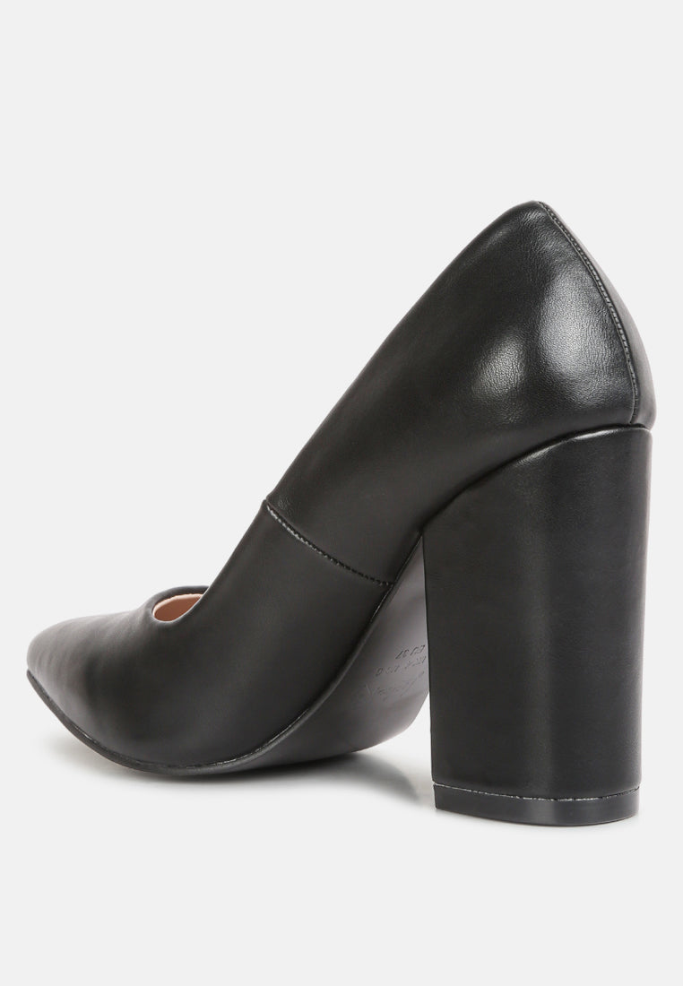 Black faux leather pumps showing angled heel block and rounded back