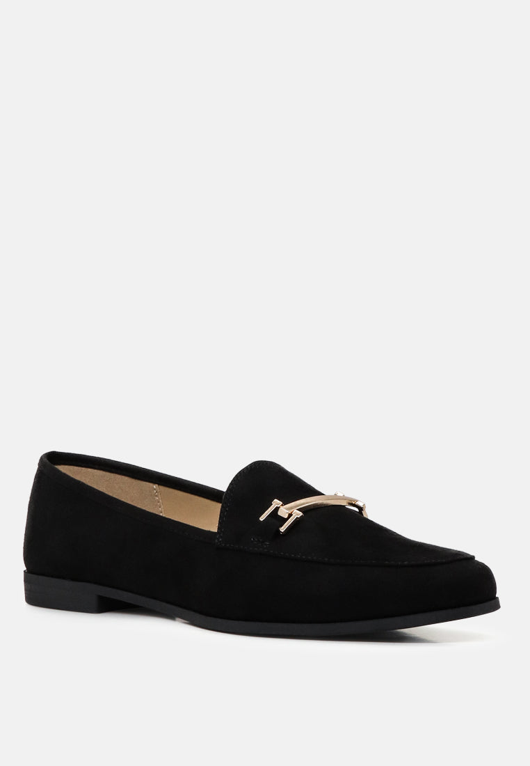 Black faux suede loafer, curved toe and metal strap buckle detail, angled side