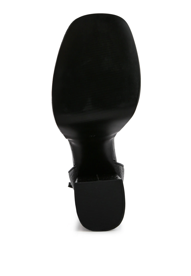 Black high block heel sandal sole view with croc texture and ankle strap