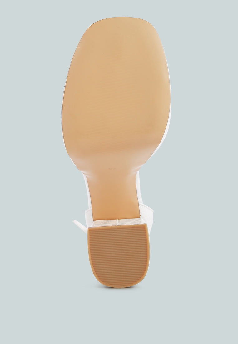 White croc-textured sandal outsole view, platform sole under tall heel