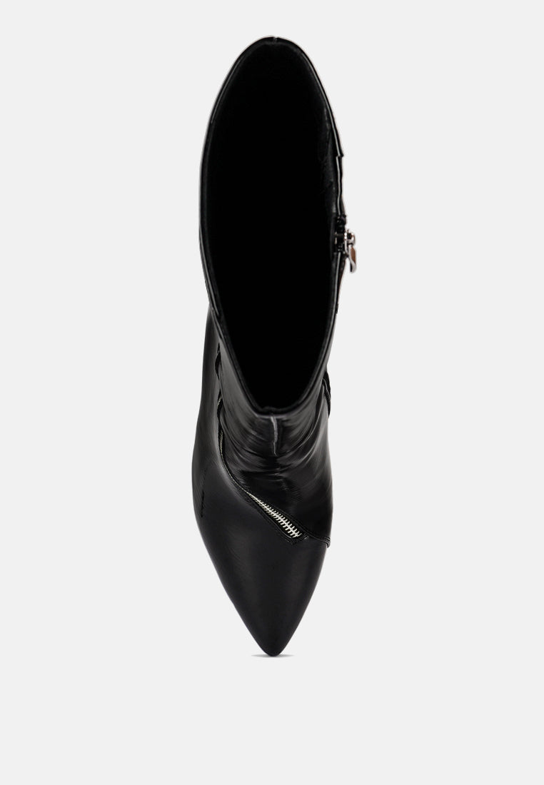 Black pointed-toe boot with side zipper pull near the ankle.