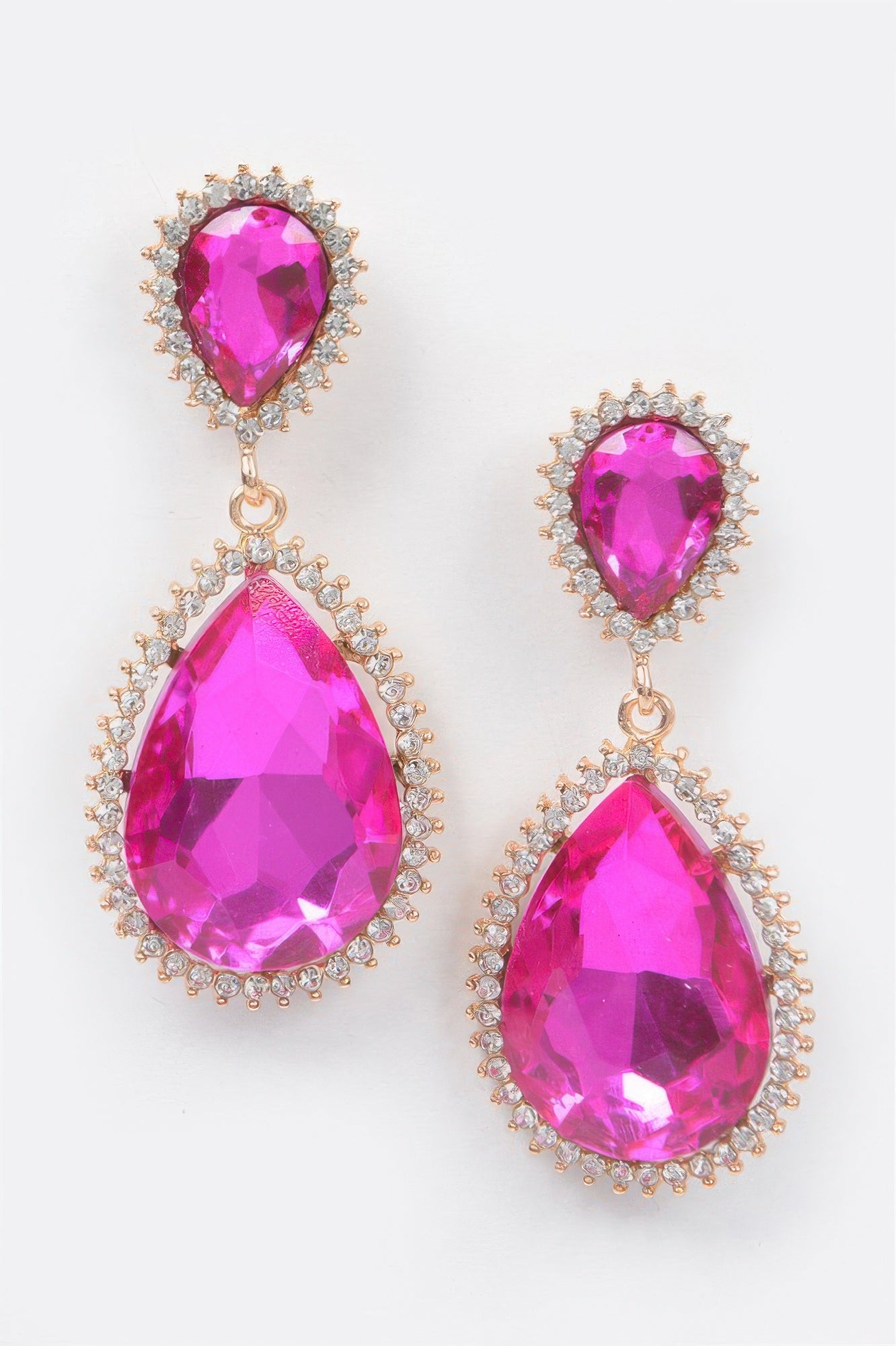 Fuchsia pink rhinestone dangle earrings with gold-tone halos and teardrop drops