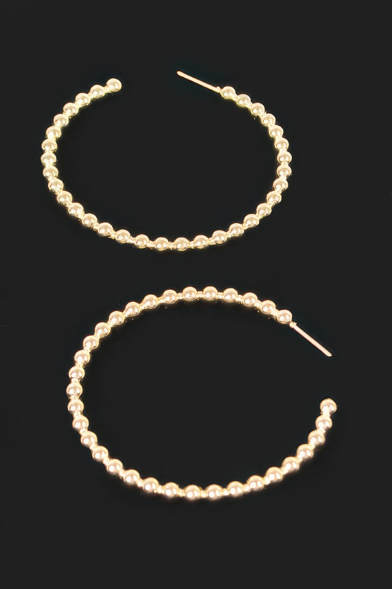 Gold metal hoop earrings with rounded bead links and straight pin