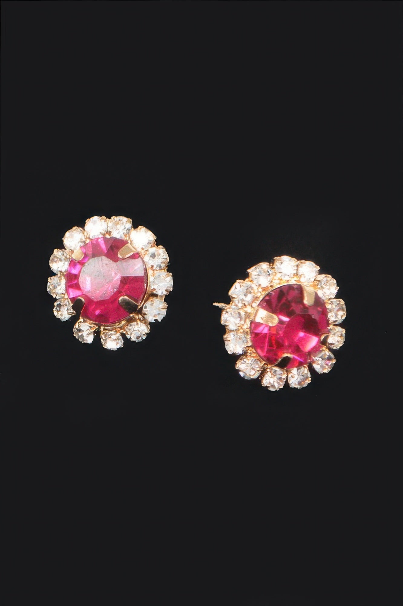 Stone stud earrings with fuchsia round crystal center and clear halo, gold-tone posts
