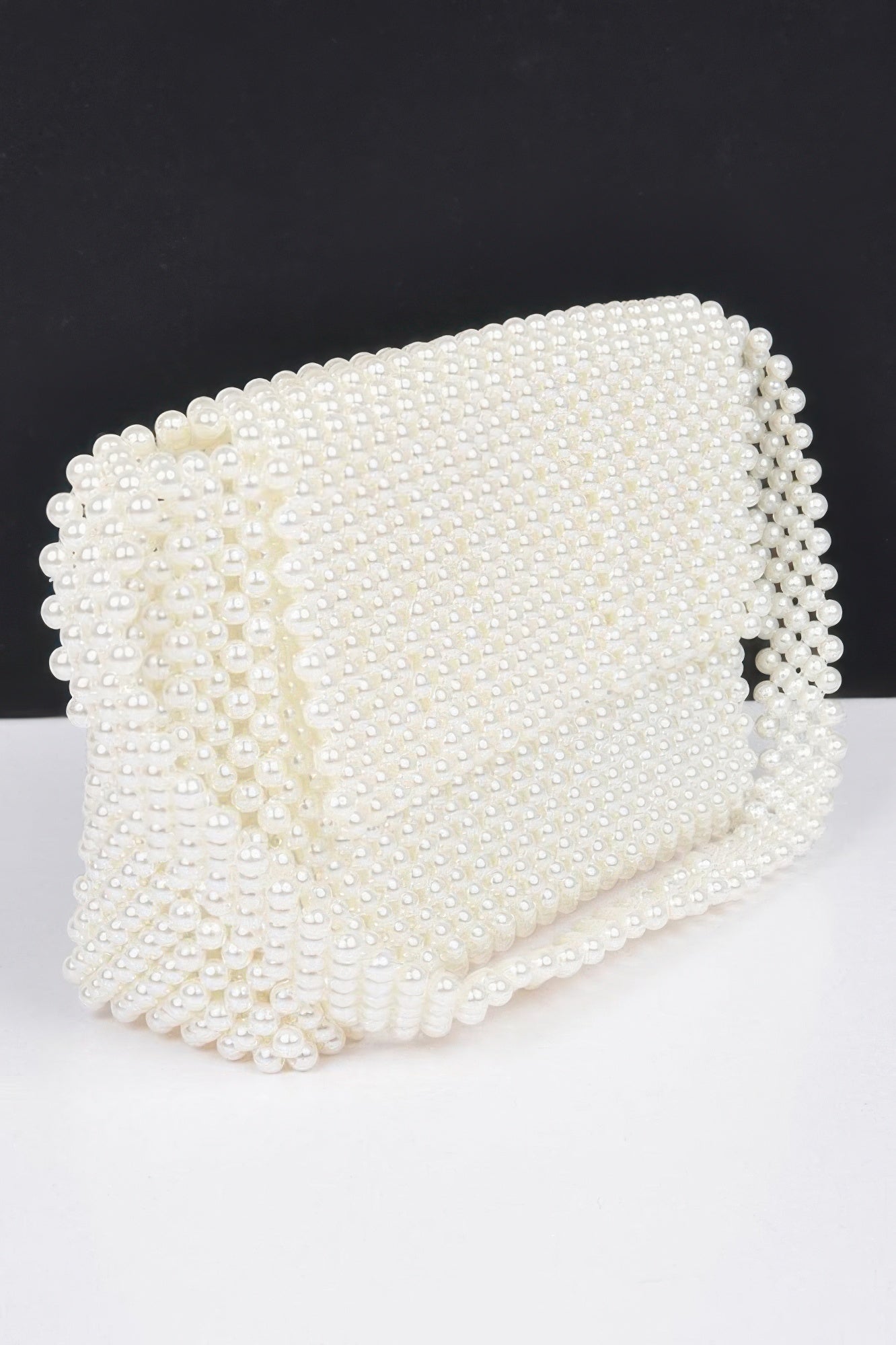 Cream faux pearl beaded flap shoulder bag, front close-up with rounded shape