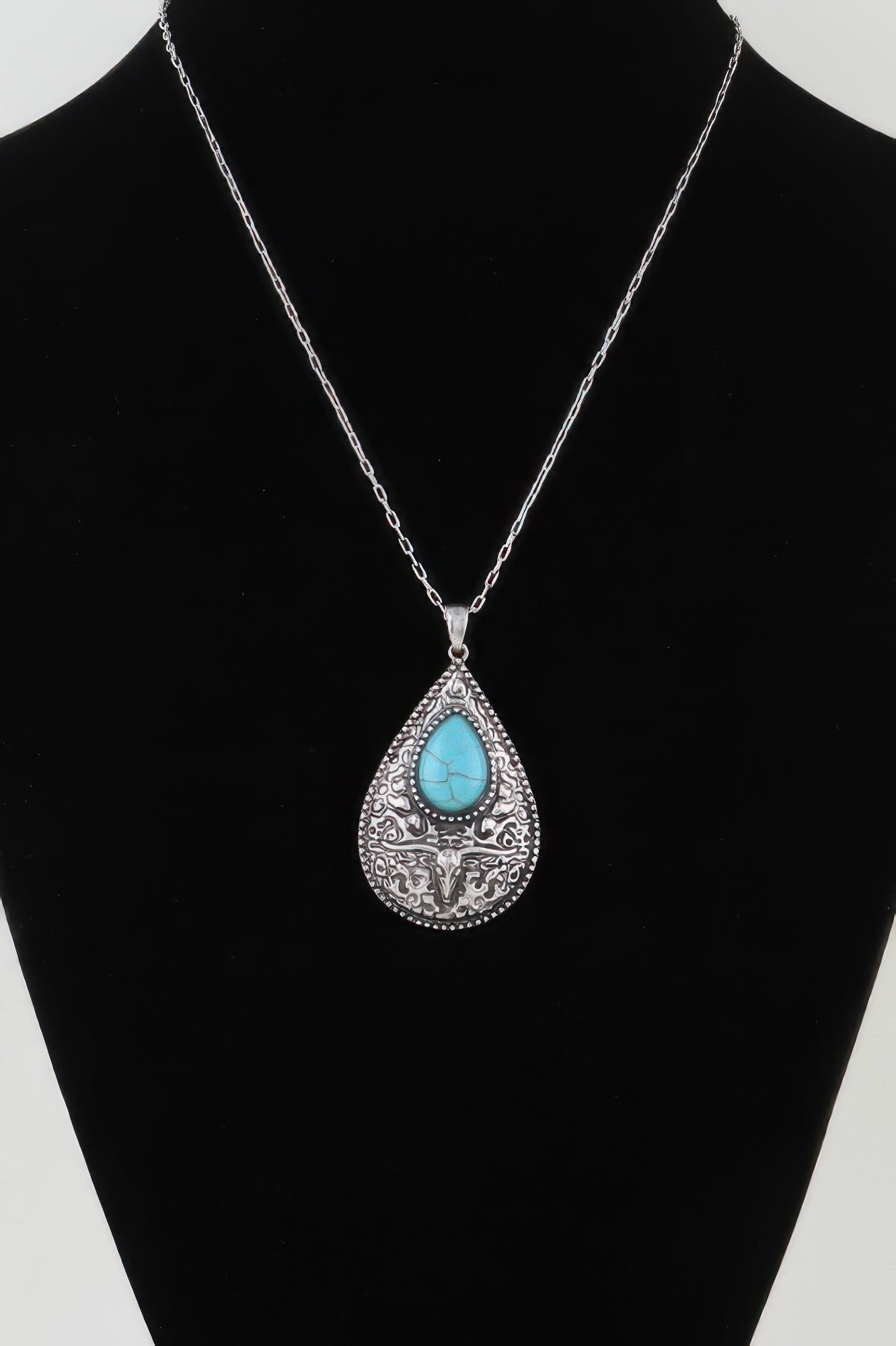 Antique bull teardrop necklace with turquoise center and silver-tone filigree pendant