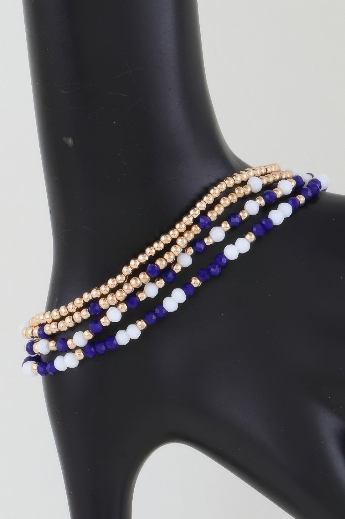 Alternating stone beaded bracelet with gold beads and blue-and-white beads
