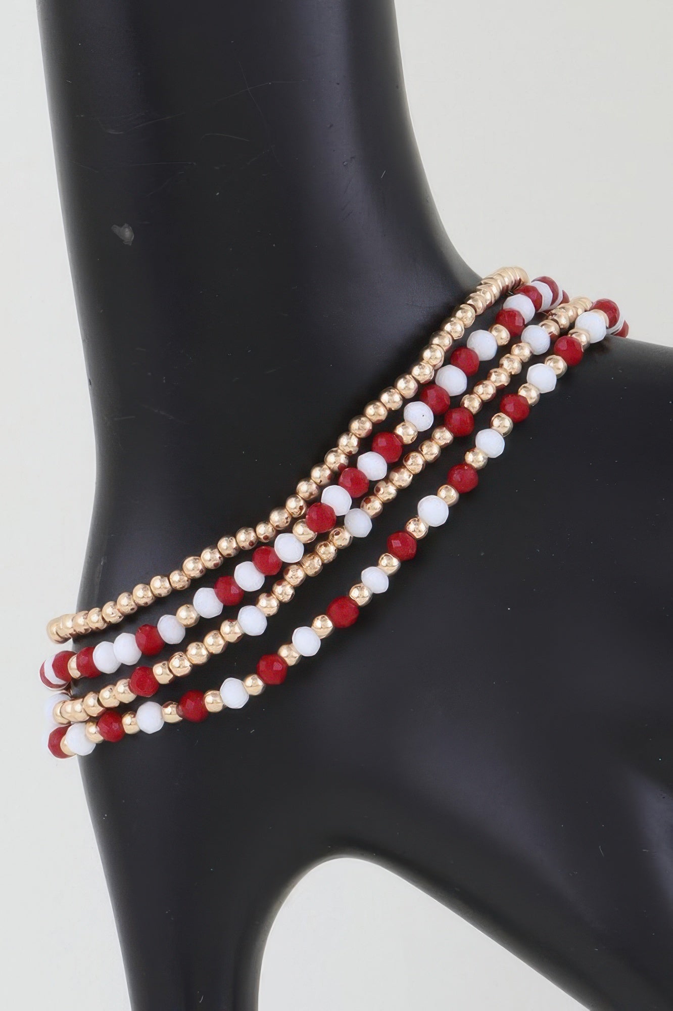 Alternating stone beaded bracelet with gold beads and red-and-white beads