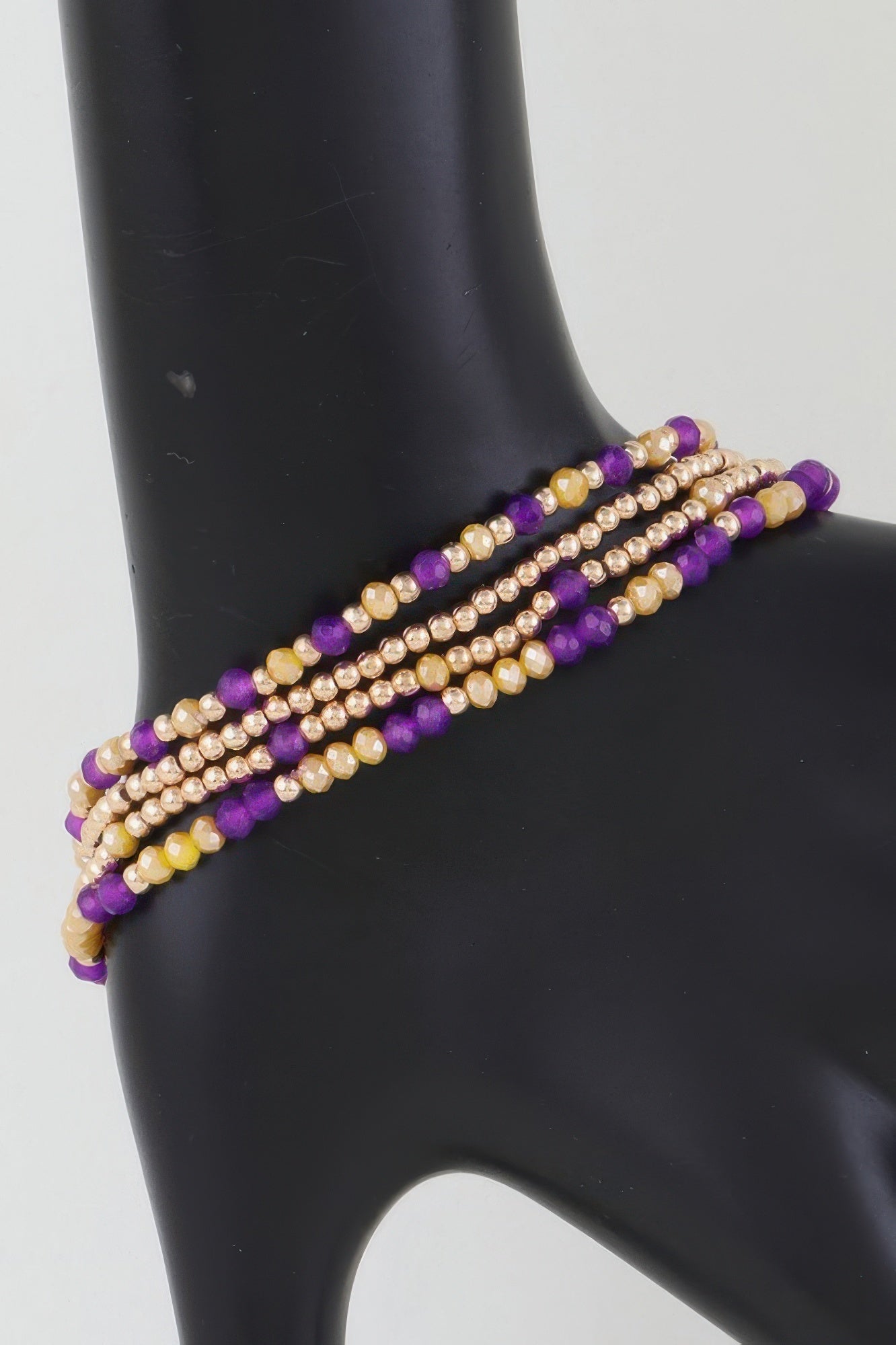 Alternating stone beaded bracelet with gold beads and purple accents