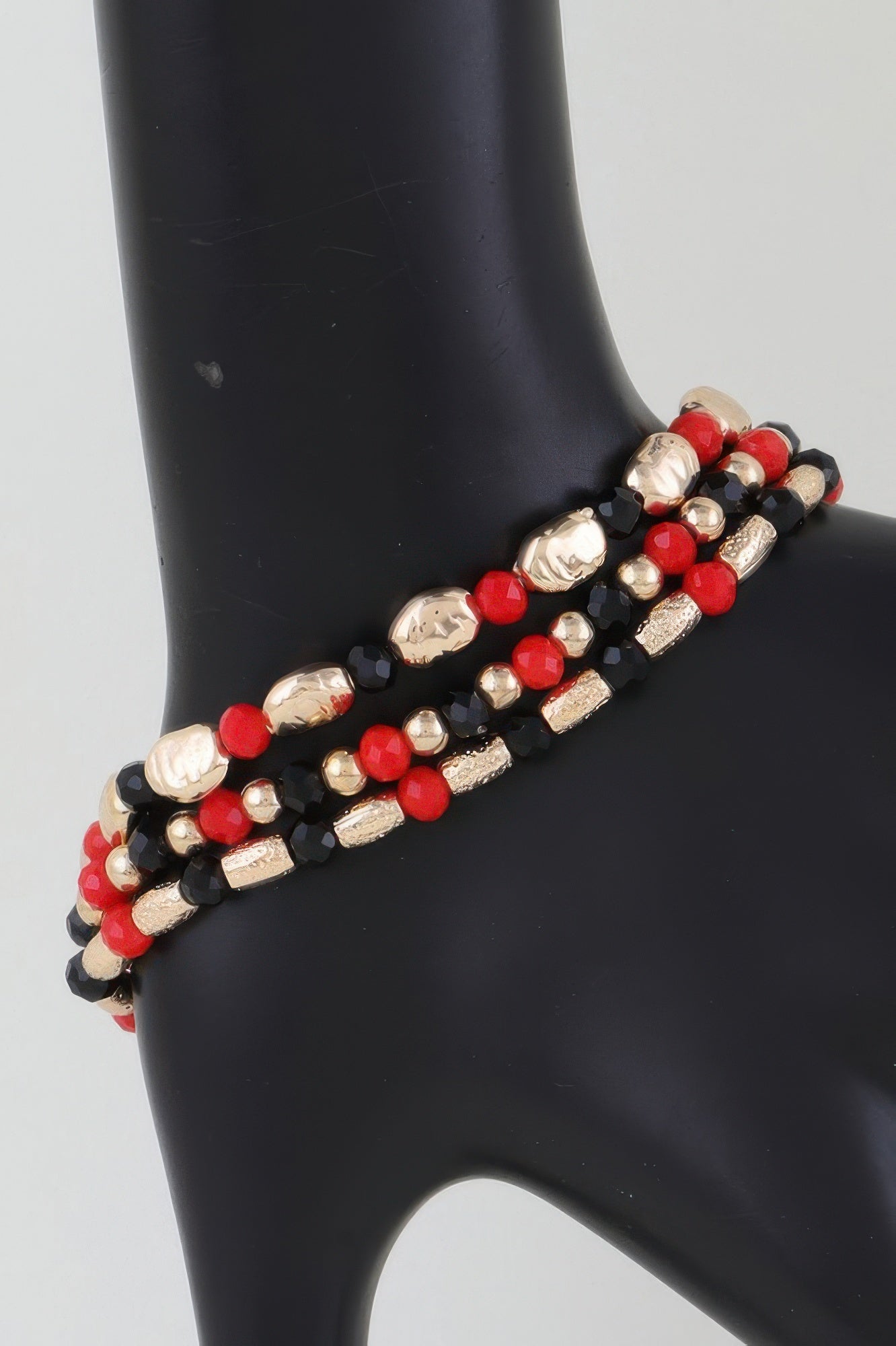 Multi tone stone beaded bracelet with red, black, and gold-look beads