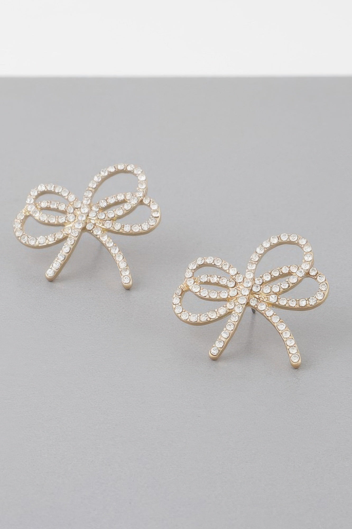 Double jeweled ribbon earrings, clear rhinestones set in ribbon bows with dangling ear pins