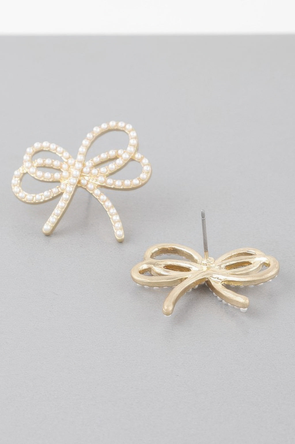 Double jeweled ribbon earrings, pearl-like stone bows with small dangling stud posts, gold-tone