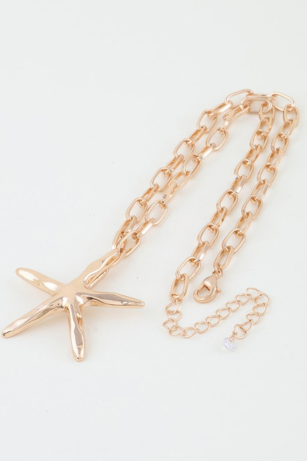 Gold starfish pendant with chunky oval link chain, layered view