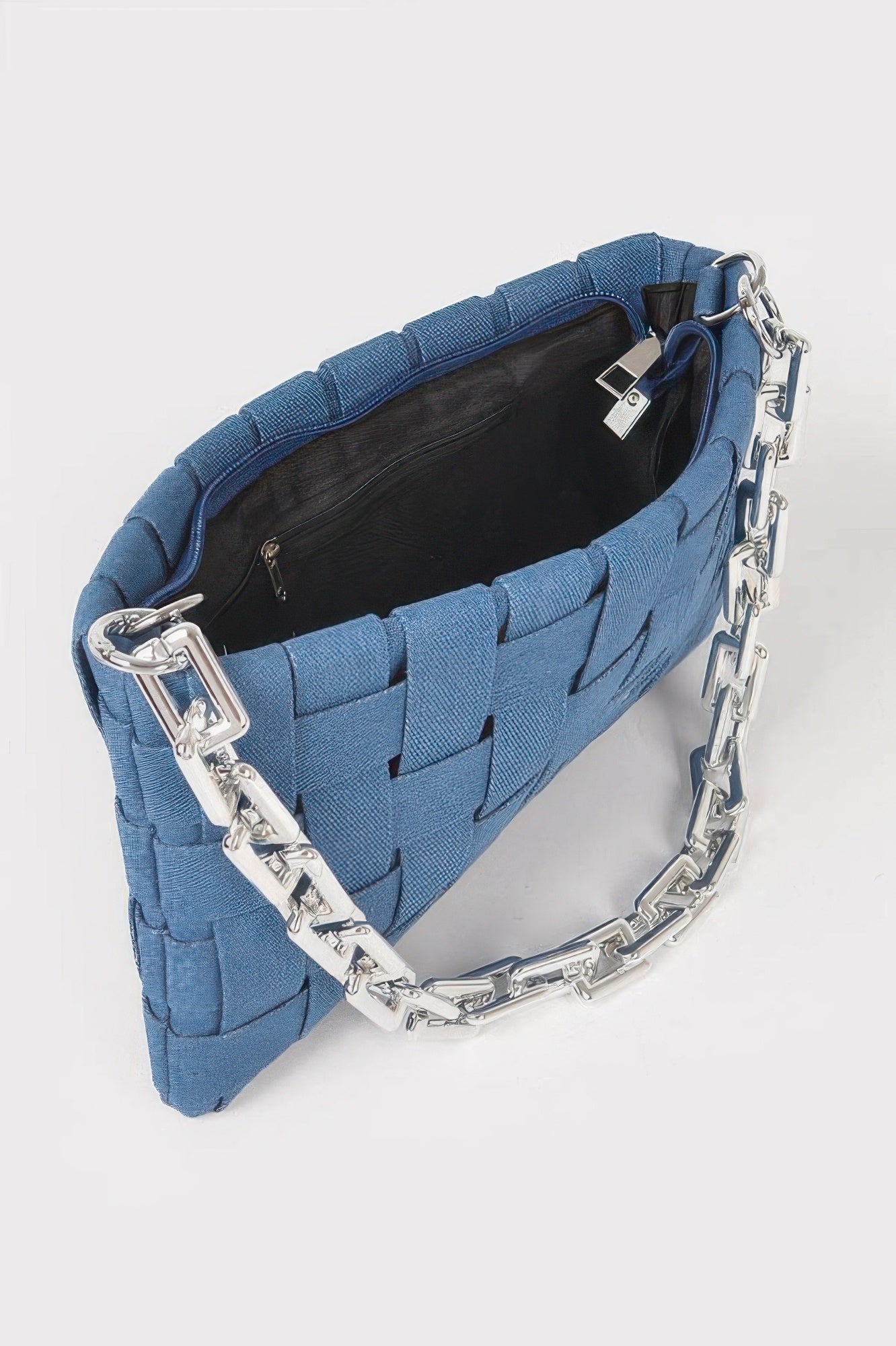 Blue braided denim shoulder bag open with black lining and silver chain hardware