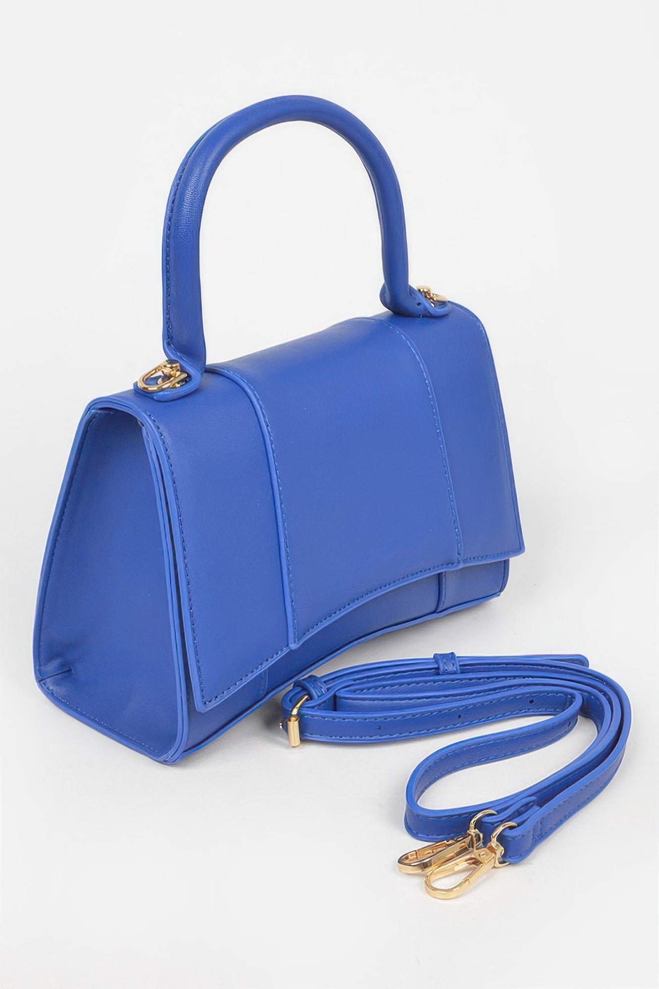 Cobalt blue faux leather top-handle bag with compact shape and crossbody strap