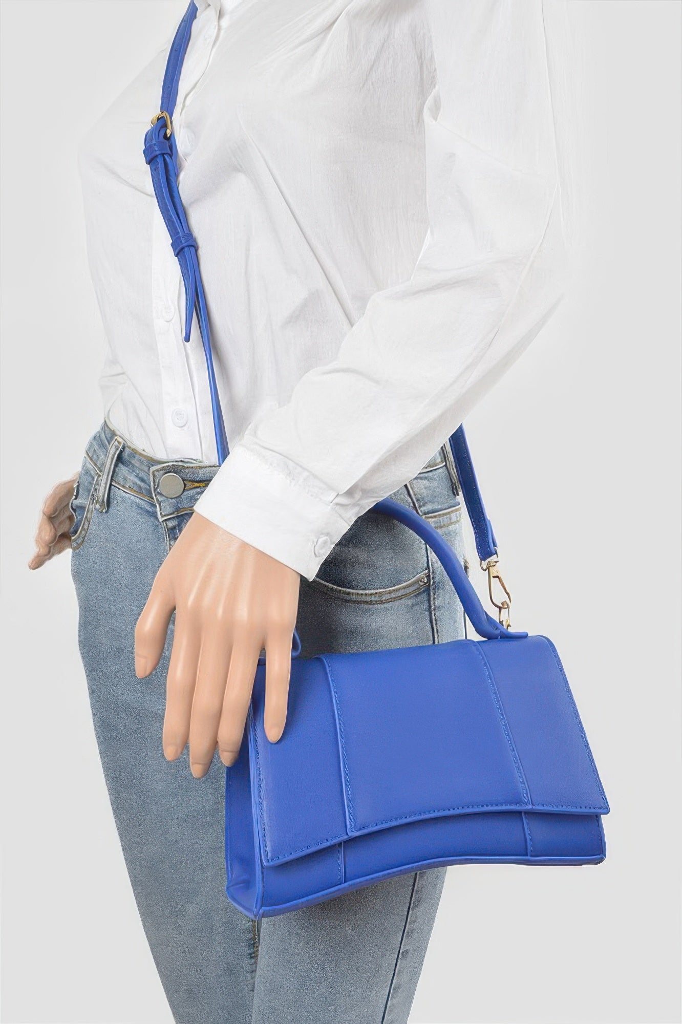 Faux leather top-handle bag in cobalt blue with flap and shoulder strap