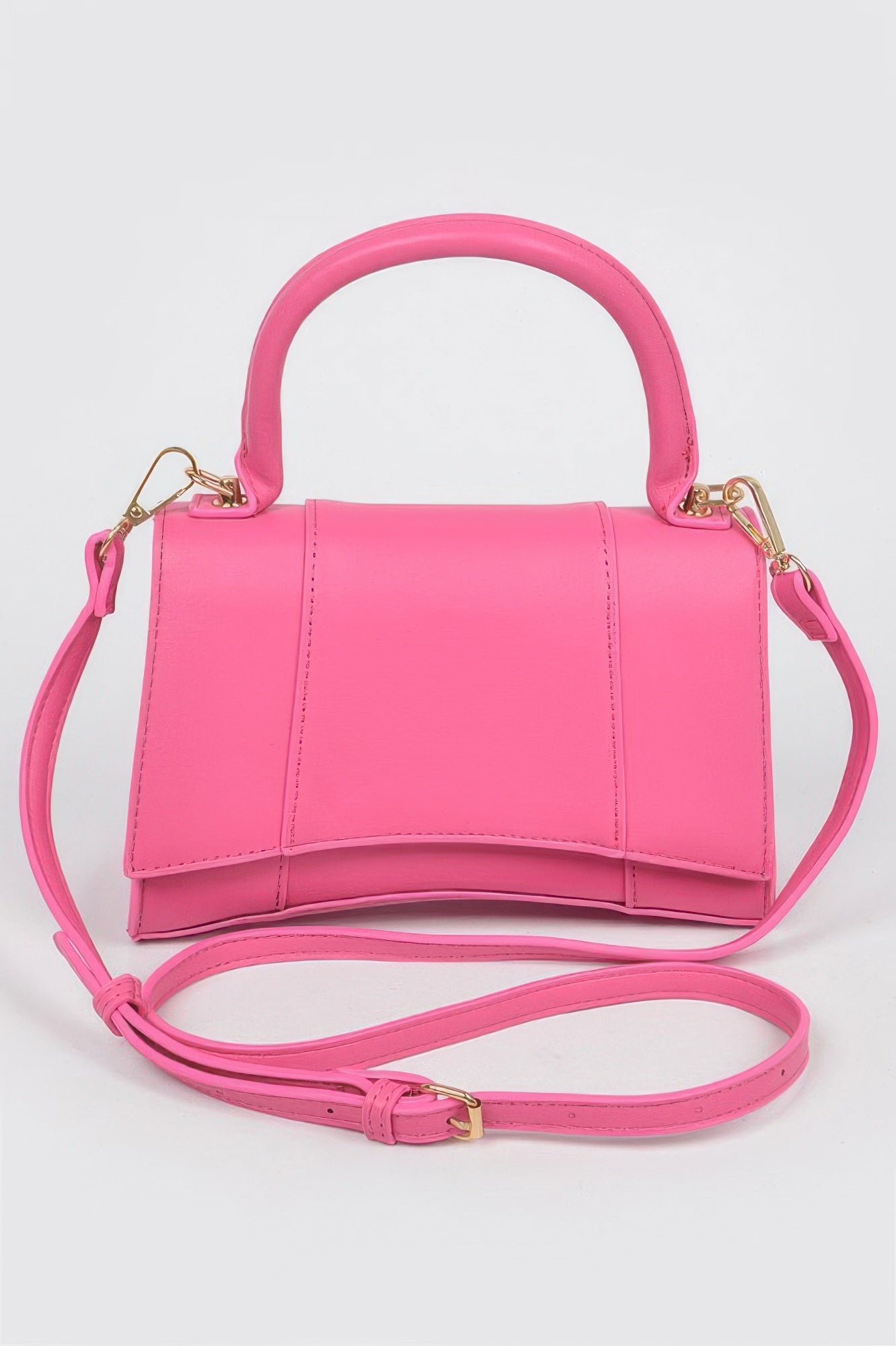 Faux leather top-handle bag in pink with front flap and crossbody strap