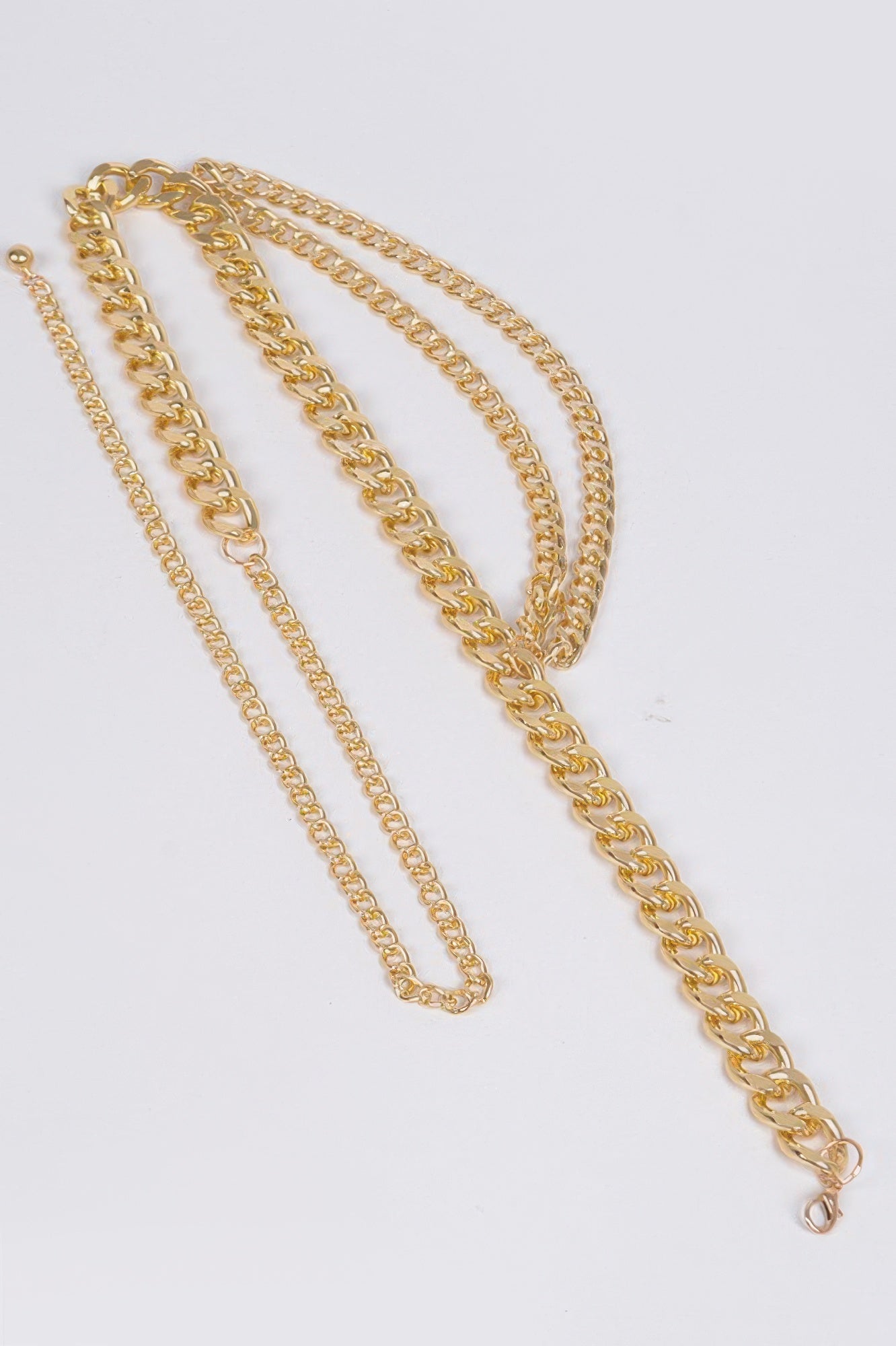Gold layered chain belt with multi-link strands and long hanging tassel