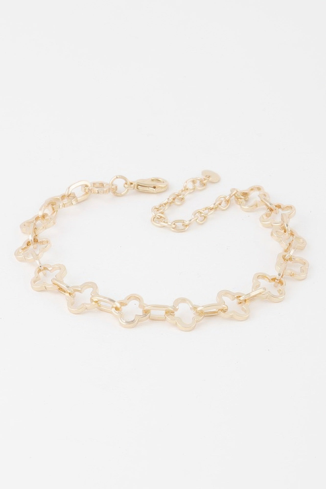 Clover link chain bracelet in gold-tone, alternating clover-shaped links and chain