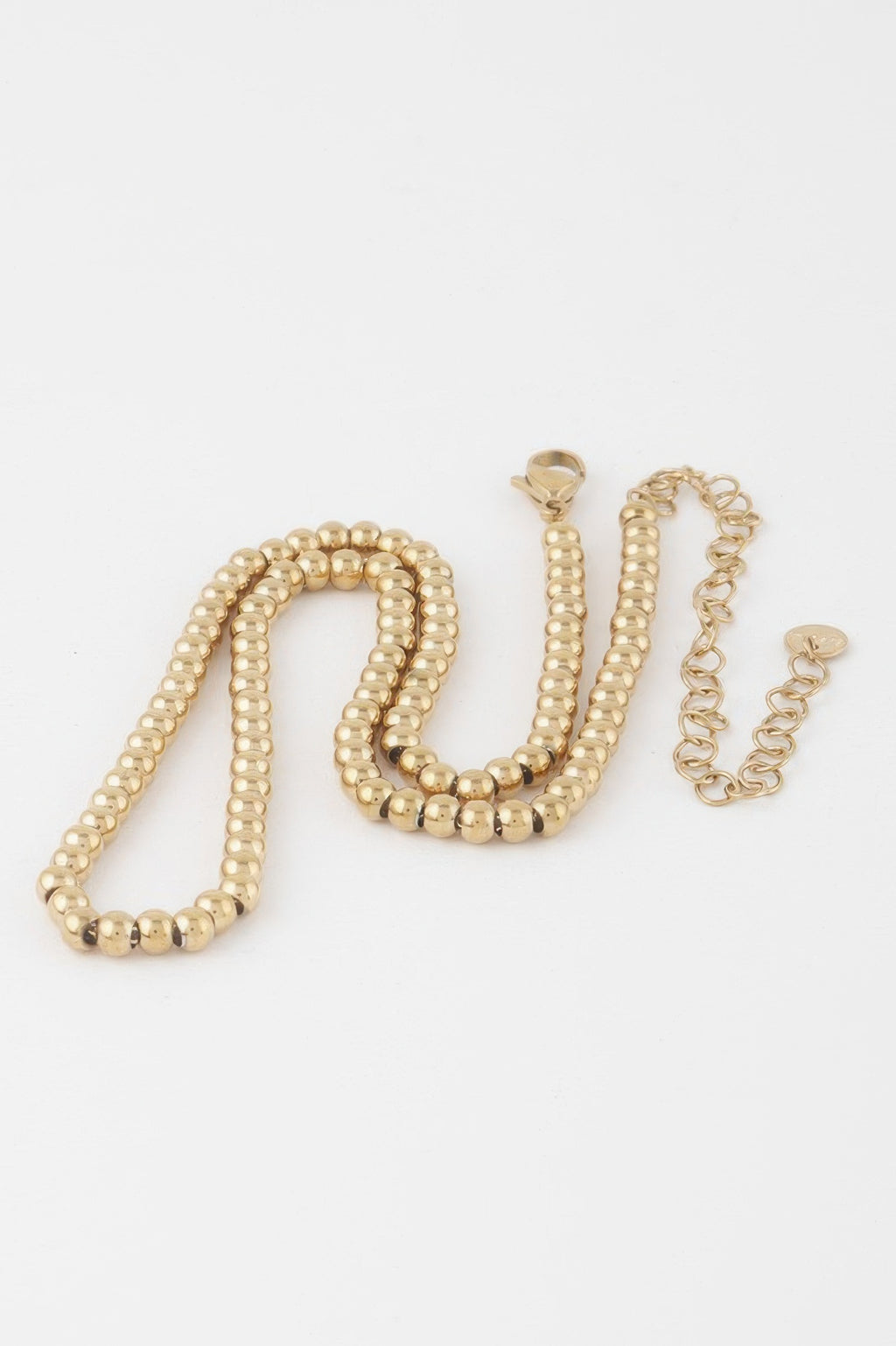 Gold beaded necklace with matching clasp and short chain extension