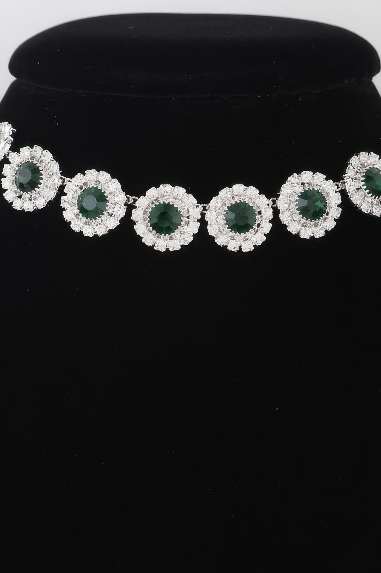 Emerald green rhinestone choker with evenly spaced circular halo settings