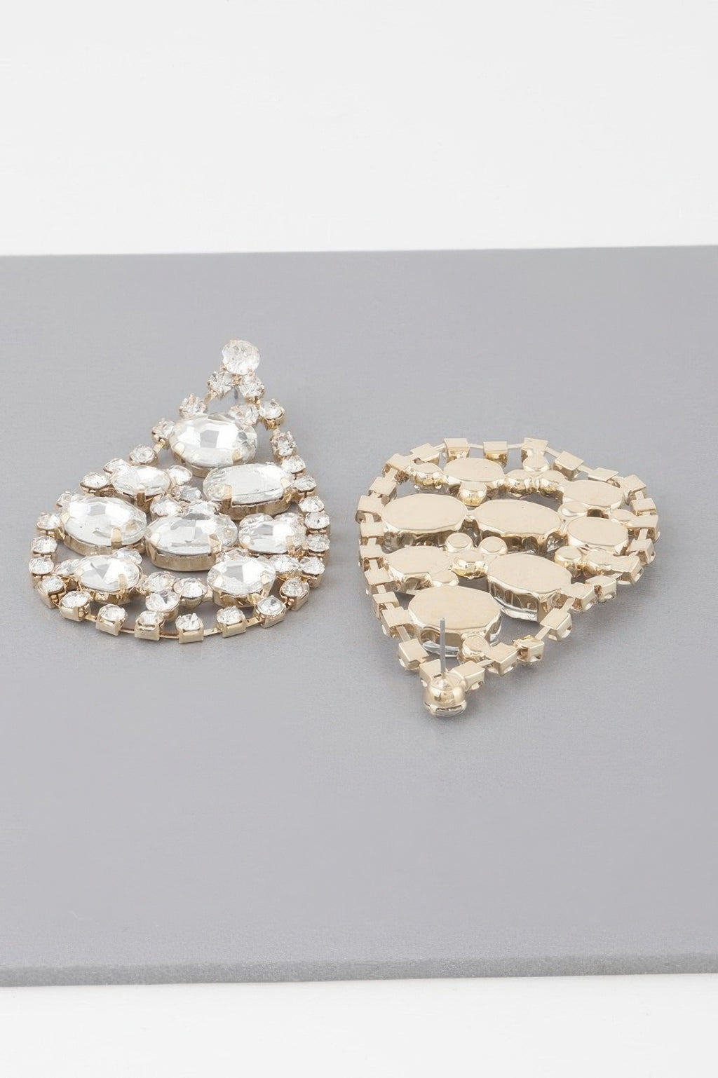 Gold-tone teardrop rhinestone earrings with clear stones, cluster dangle