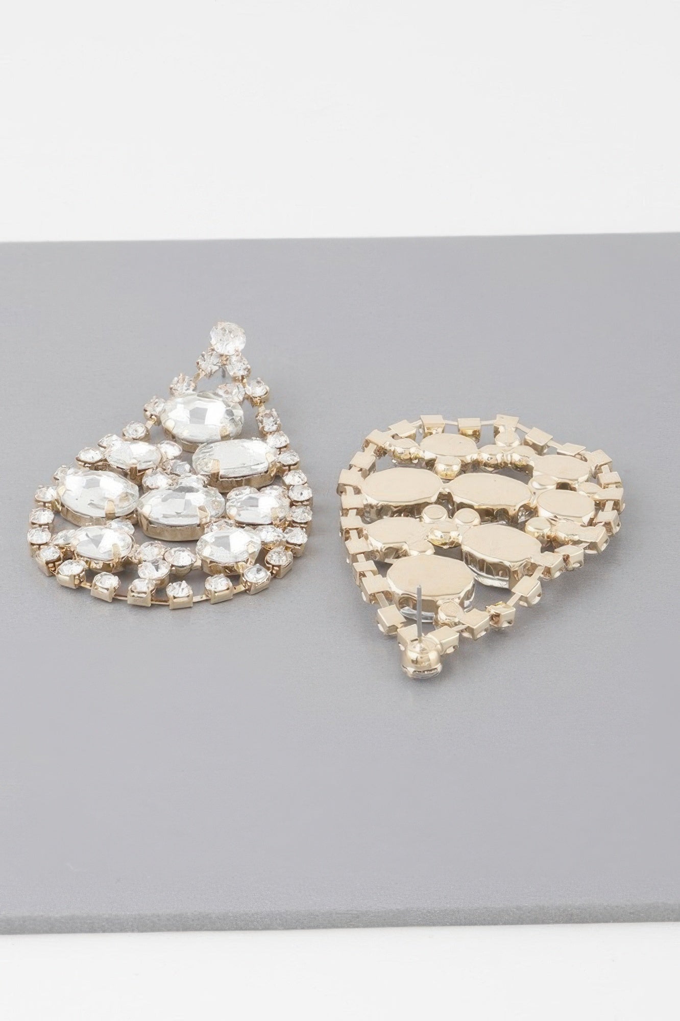 Gold-tone teardrop rhinestone earrings with clear stones, cluster dangle