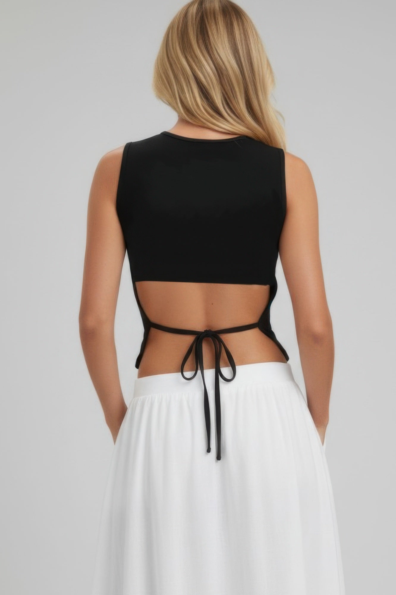 Black sleeveless mock neck top, open back with adjustable side tie strings