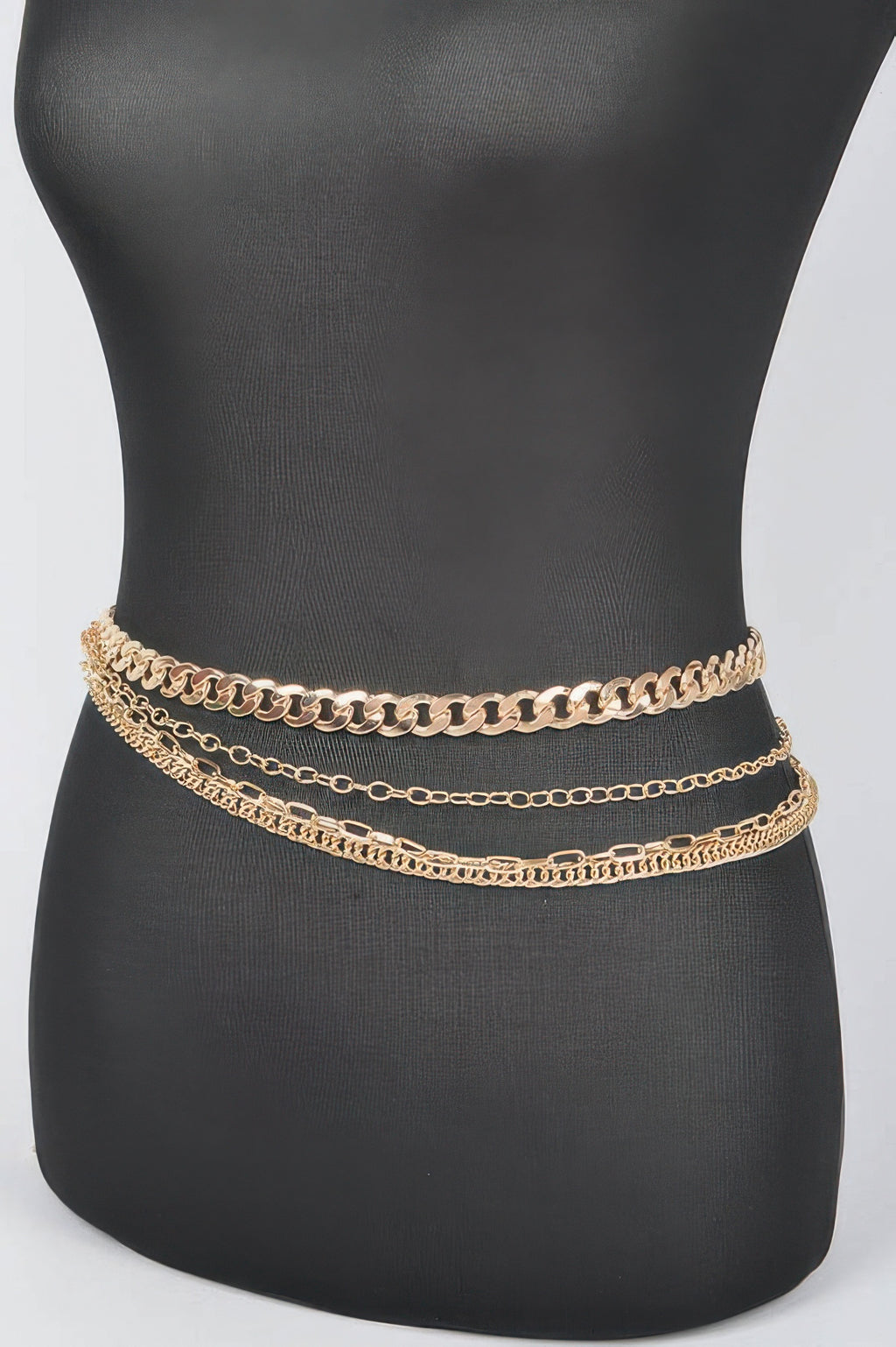 Gold-tone chain belt with three layered rows on mannequin