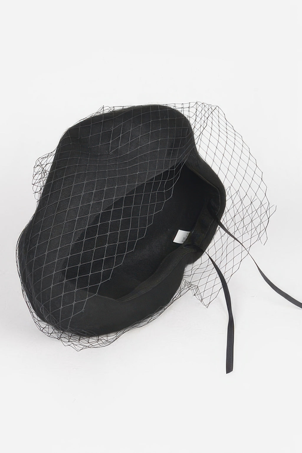 Black netted fashion cap with mesh veil and long tie strings at the side