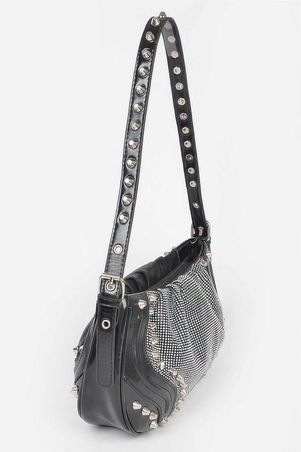 Black crossbody bag with long metal-studded strap and round grommet hardware