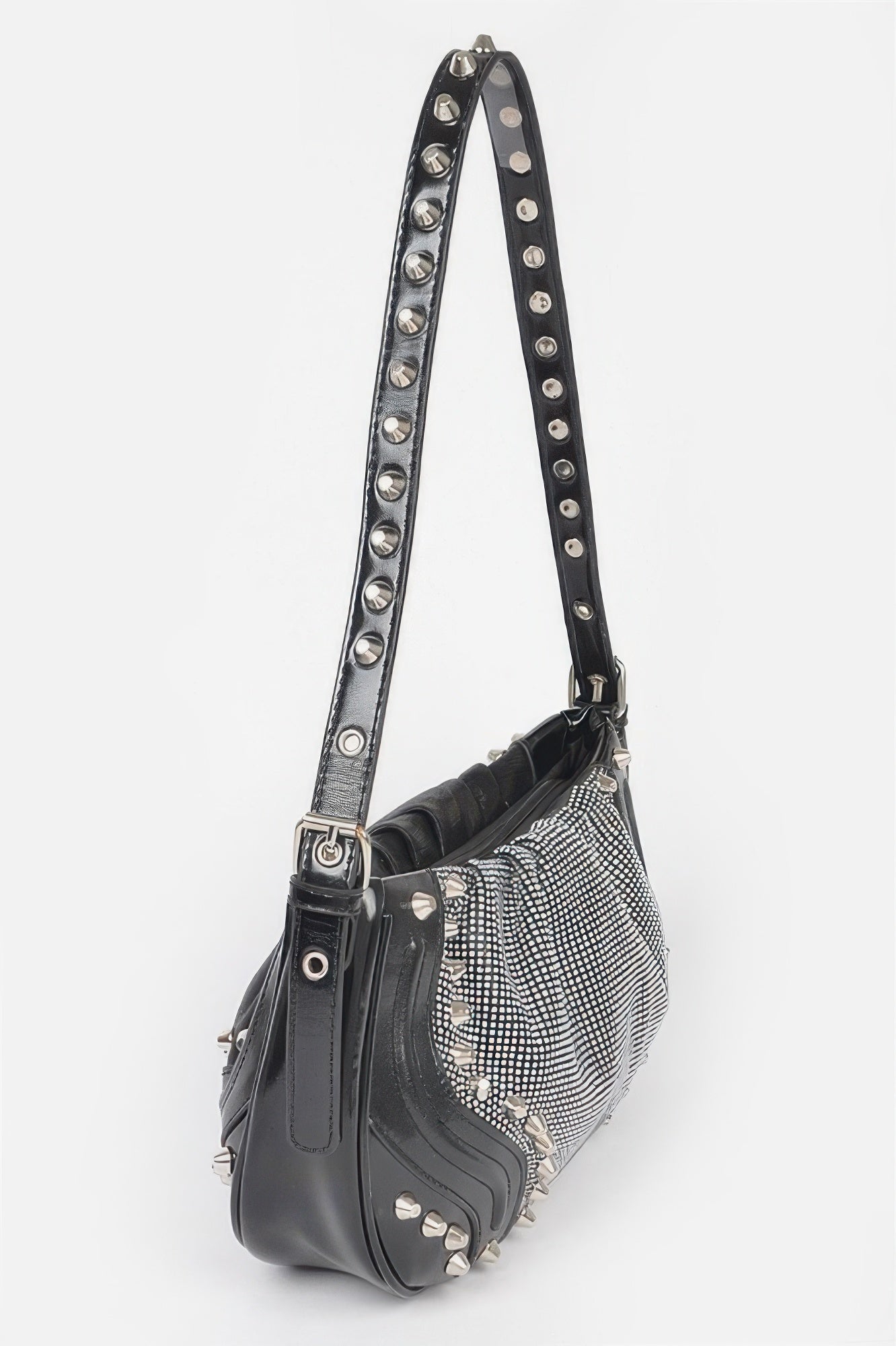 Black crossbody bag with long metal-studded strap and round grommet hardware
