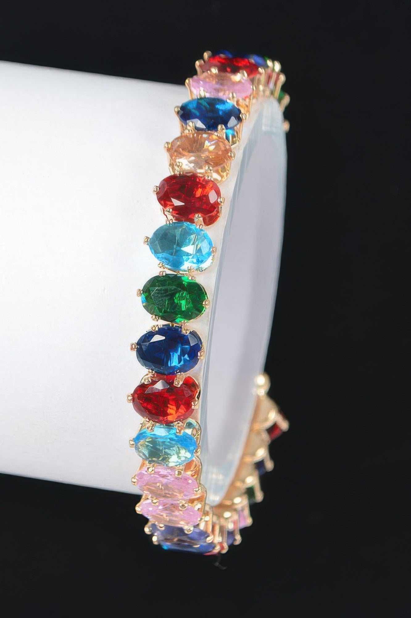 Colorful cubic zirconia bracelet with oval stones in red, blue, green, and gold-tone setting