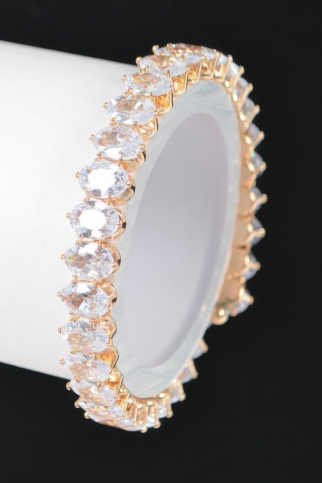 Clear cubic zirconia tennis bracelet, row of oval stones in gold-tone prongs
