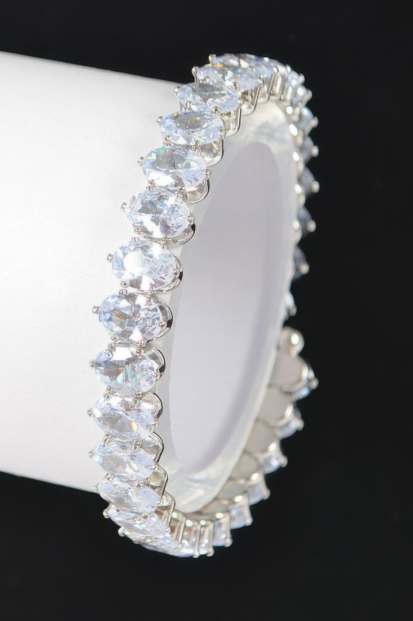 Clear cubic zirconia bracelet, close-up side view of oval stones and gold-tone band
