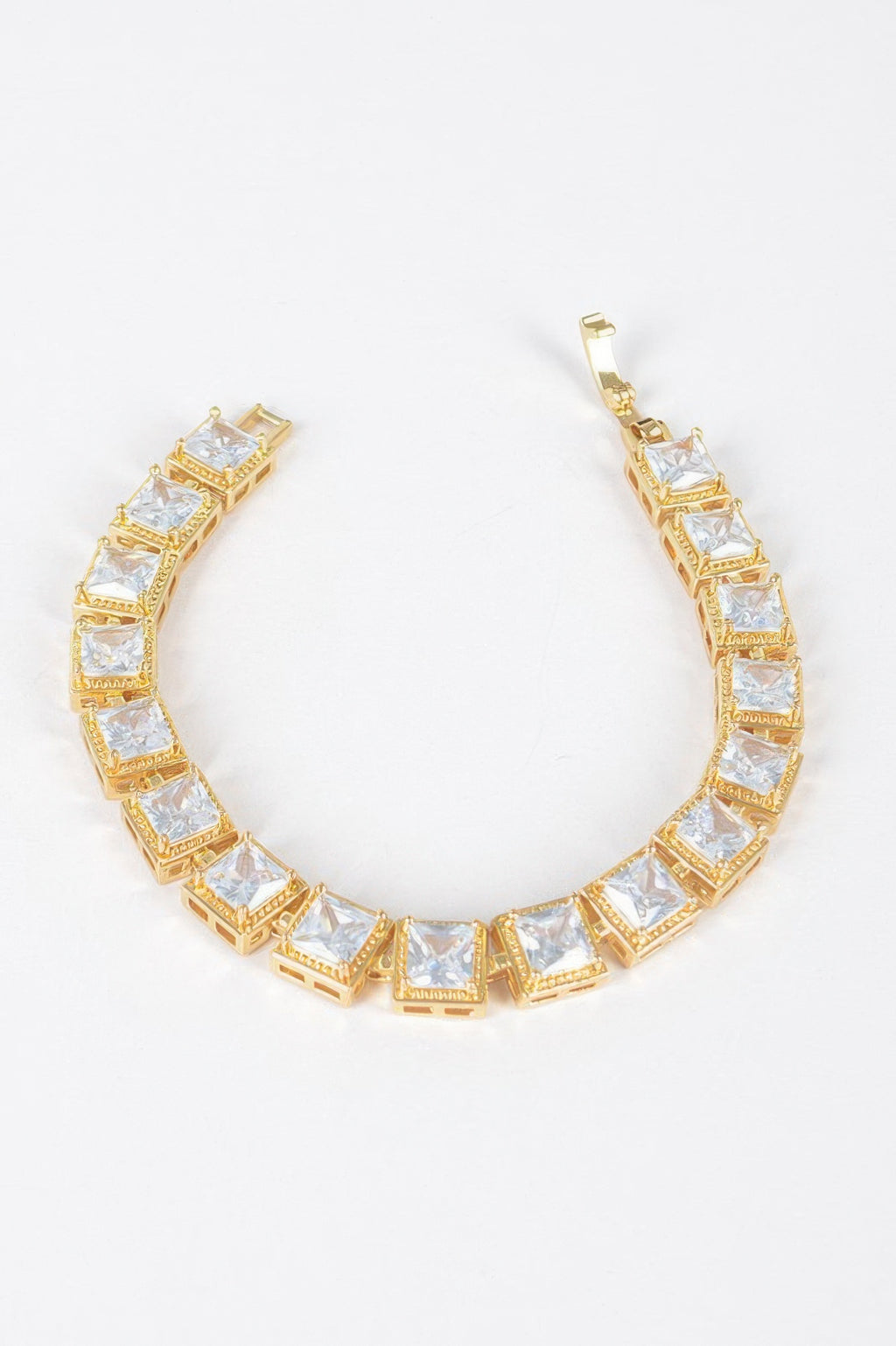 Gold-tone cubic zirconia tennis bracelet with clear square stones, open oval view