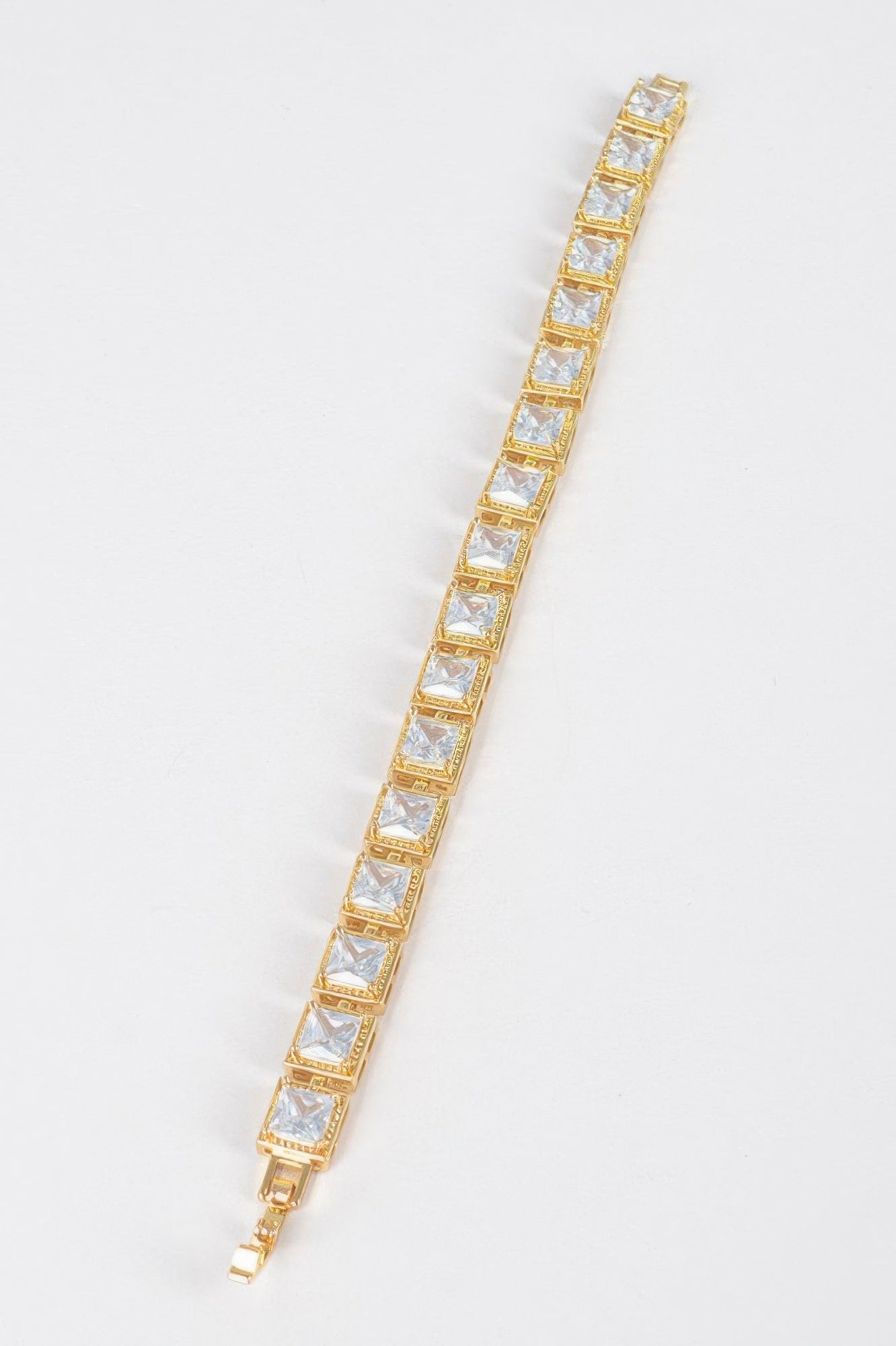 Gold-tone clear cubic zirconia bracelet with repeating square stones and clasp