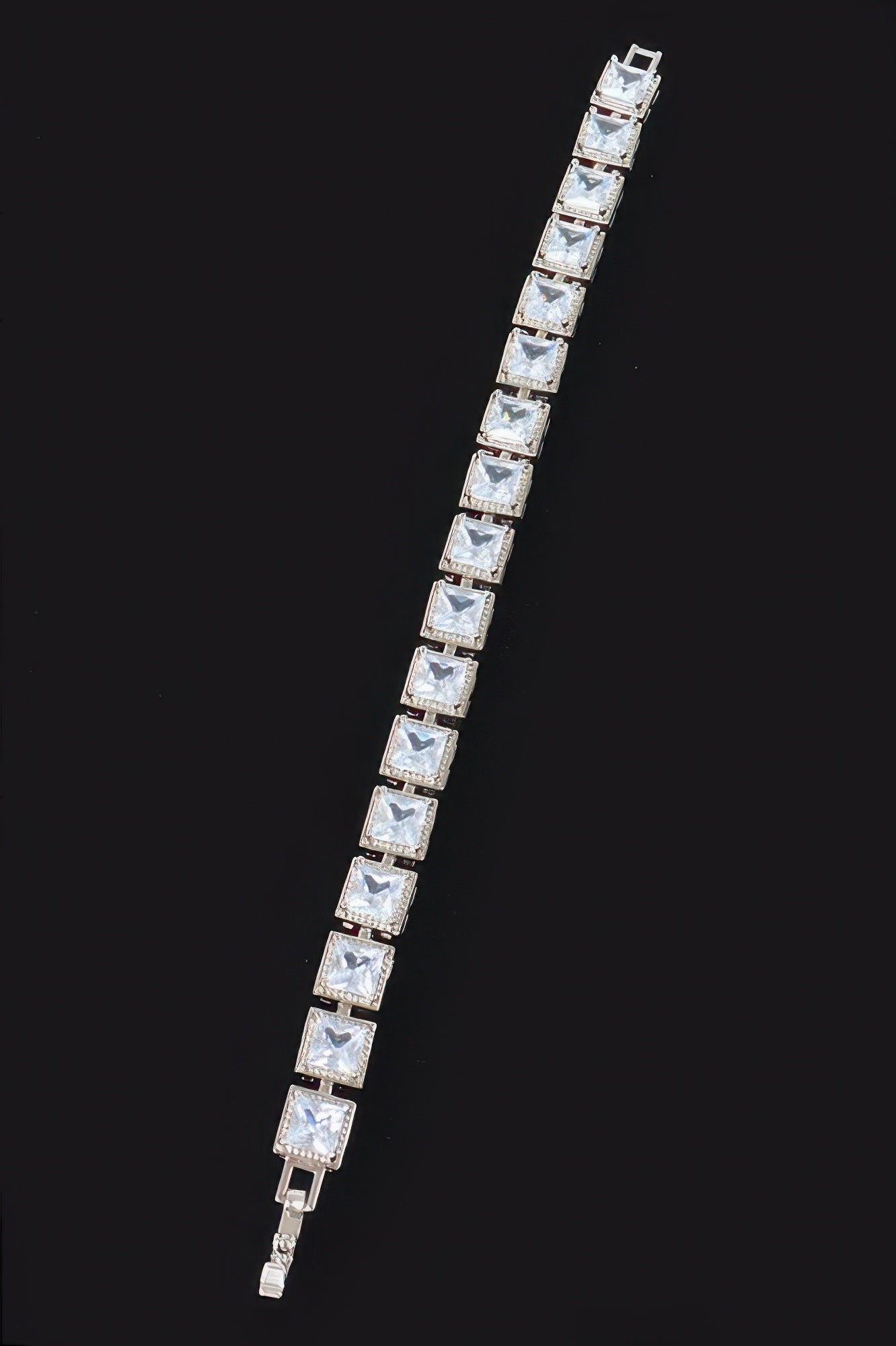 Silver-tone cubic zirconia bracelet with clear square stones in a straight row
