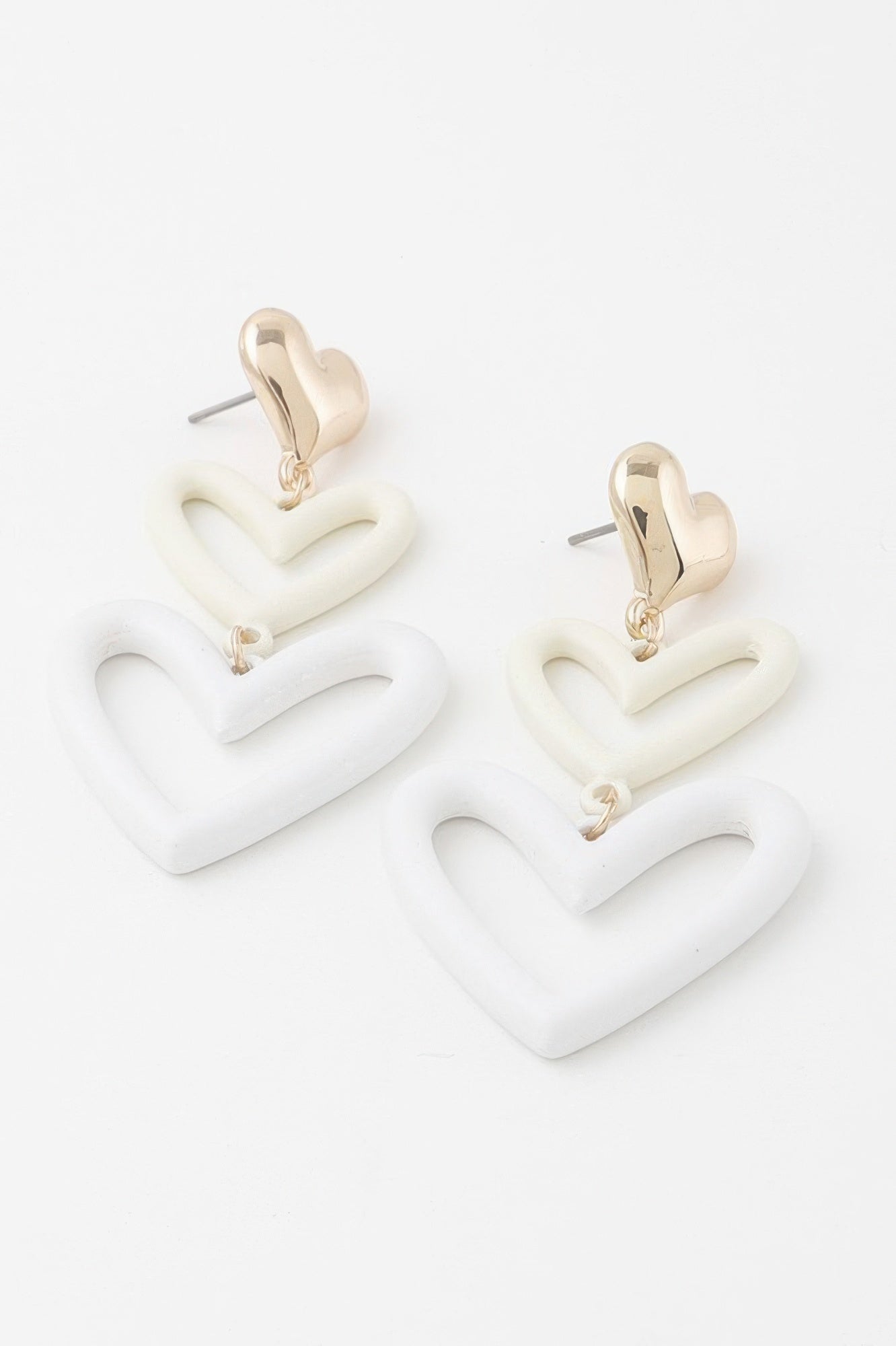 Triple Hearts drop earrings with three white stacked hearts and gold-tone hook backs