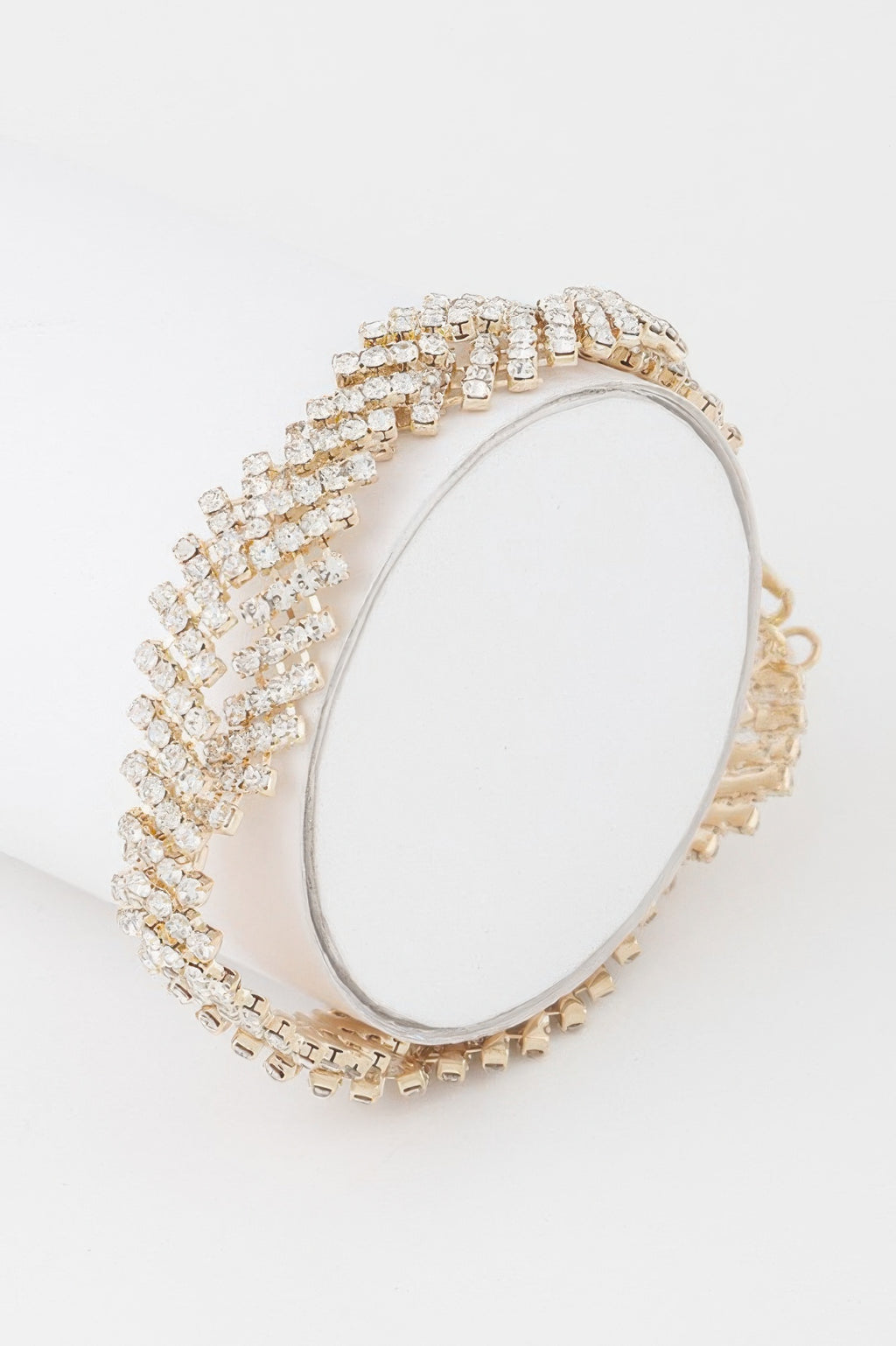 Twisted rhinestone bracelet in gold with clear stones, wide linked rows
