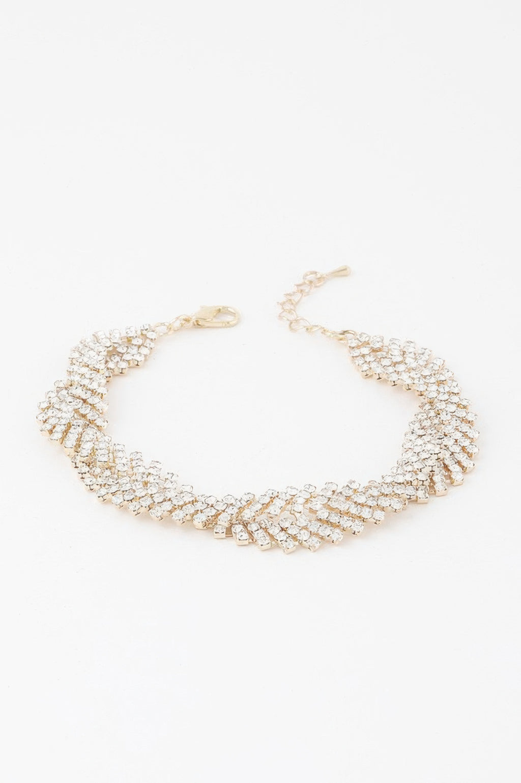 Gold twisted rhinestone bracelet with clear stones, layered linked cuff design