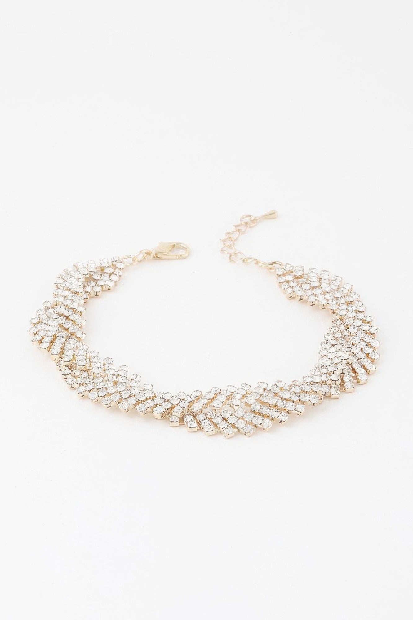 Gold twisted rhinestone bracelet with clear stones, layered linked cuff design