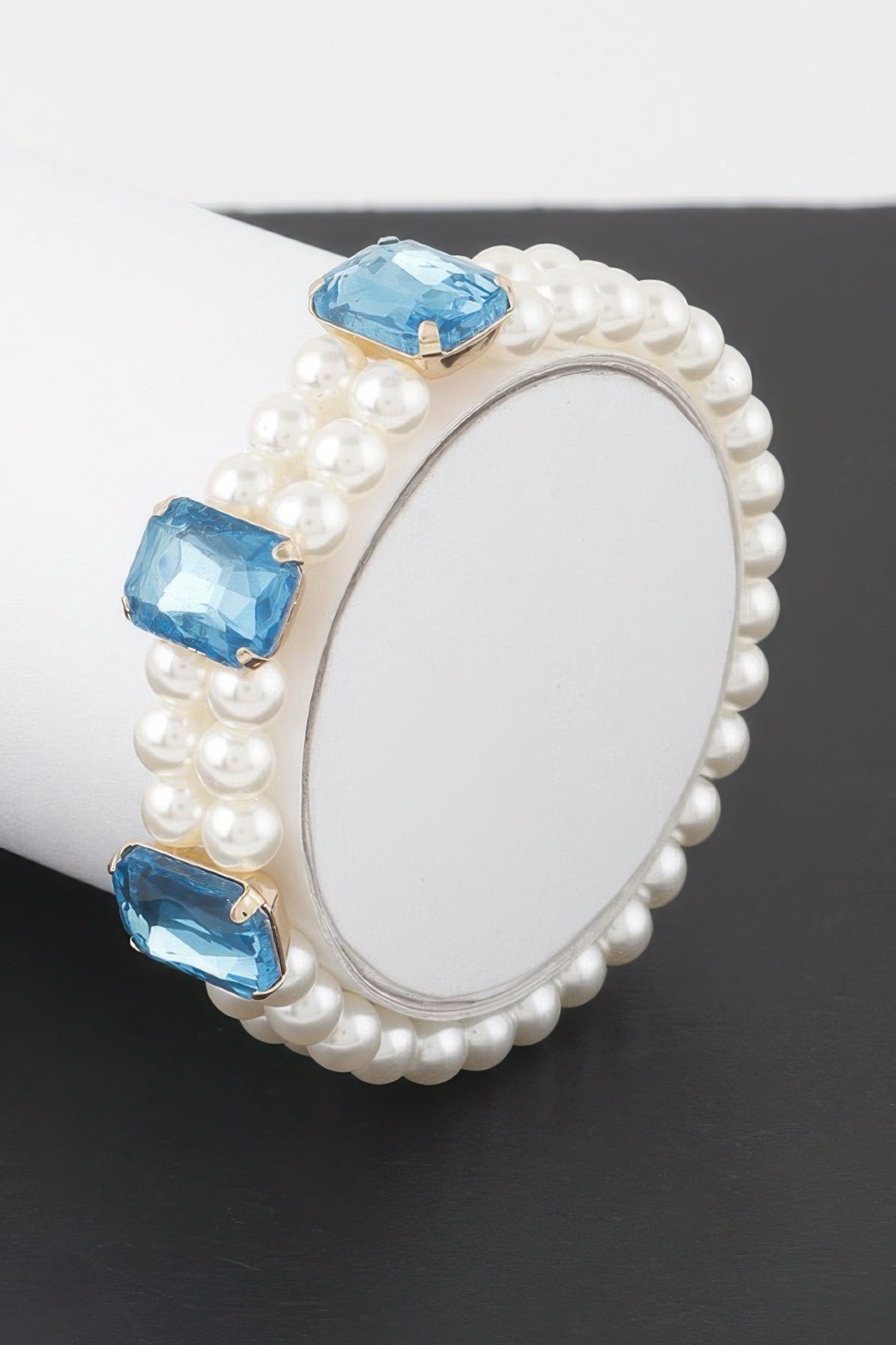 Double beaded rhinestone bracelet with white pearl strands and light blue crystal stones