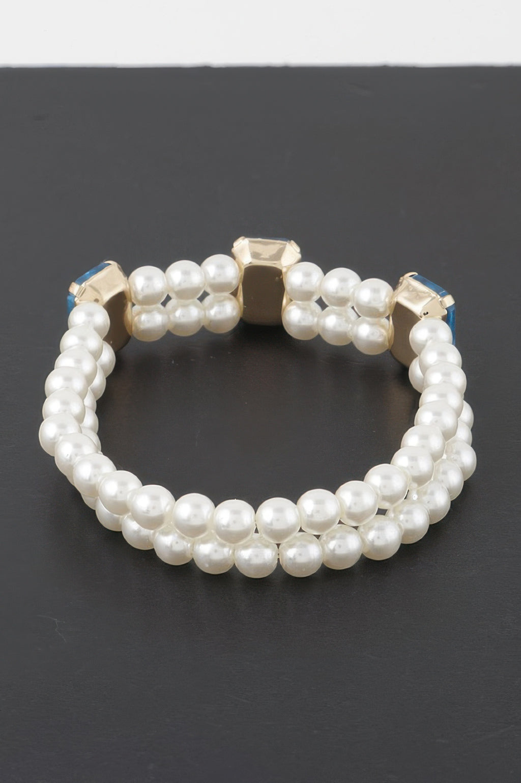 Double-strand pearl bracelet with clear rhinestone square stones and gold-tone settings