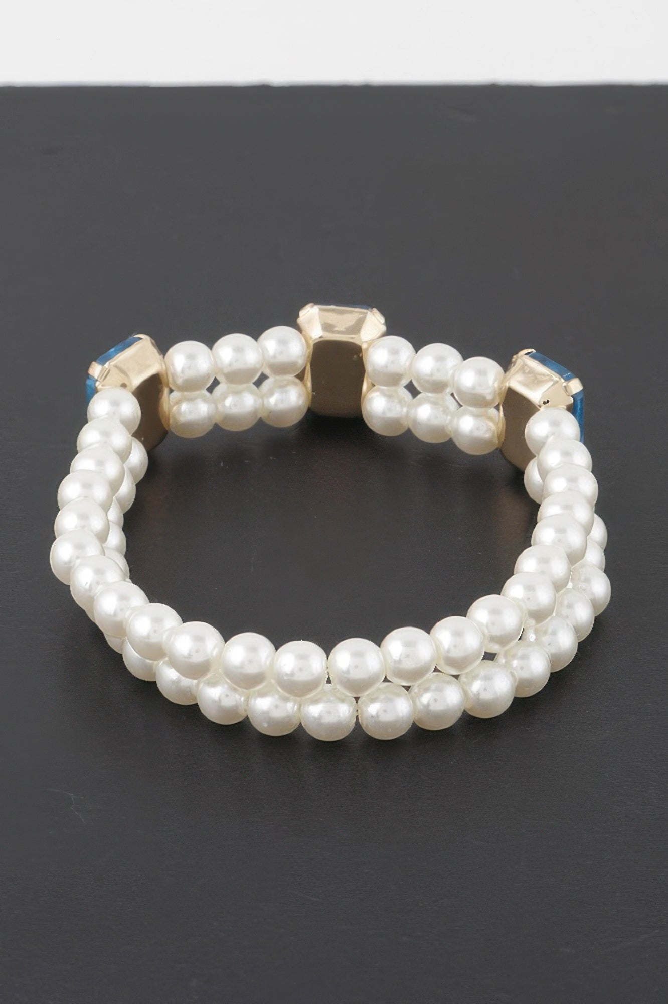 Double-strand pearl bracelet with clear rhinestone square stones and gold-tone settings