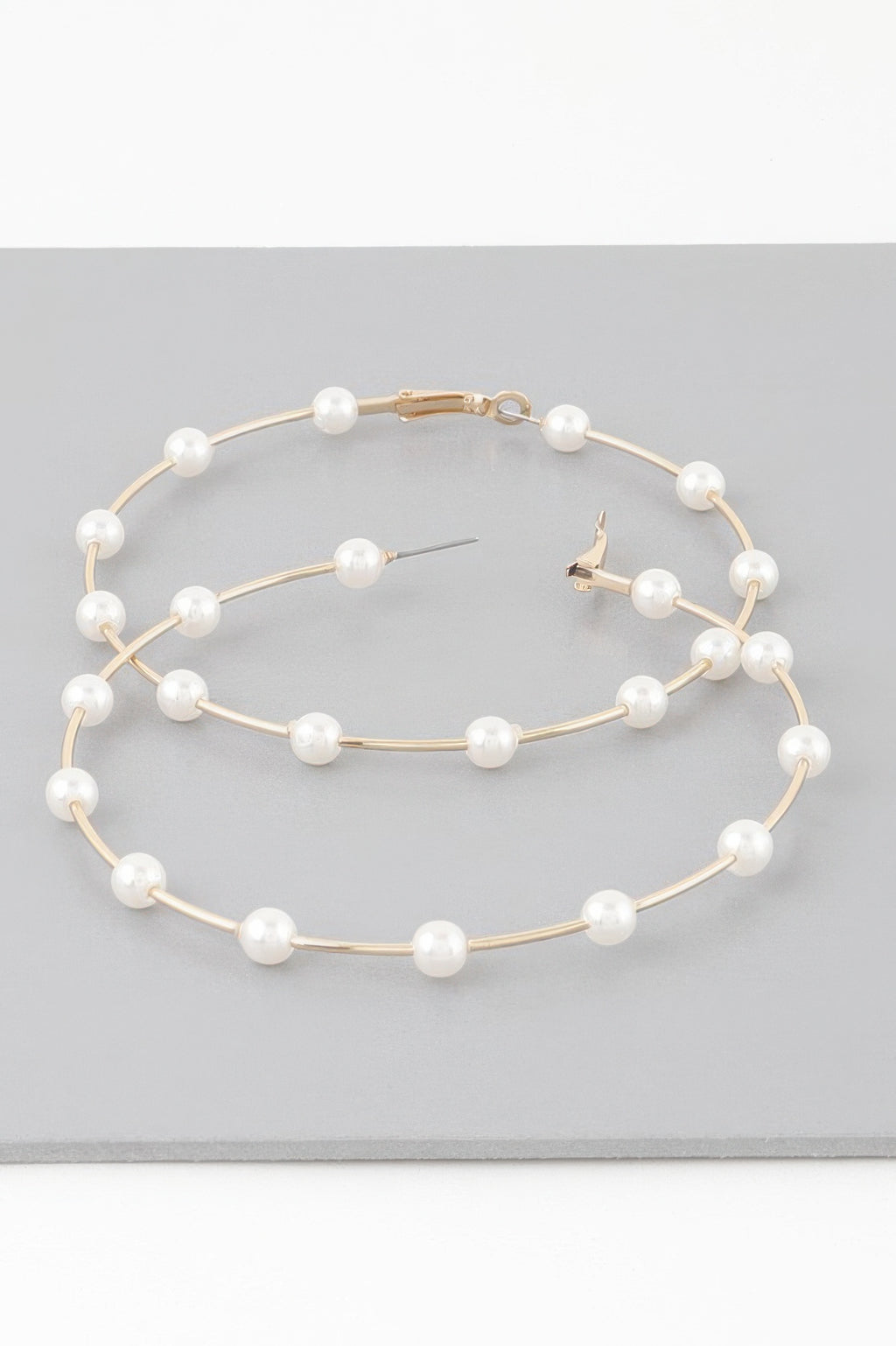 Oversized hoop earrings with cream faux pearls on gold-tone hoops