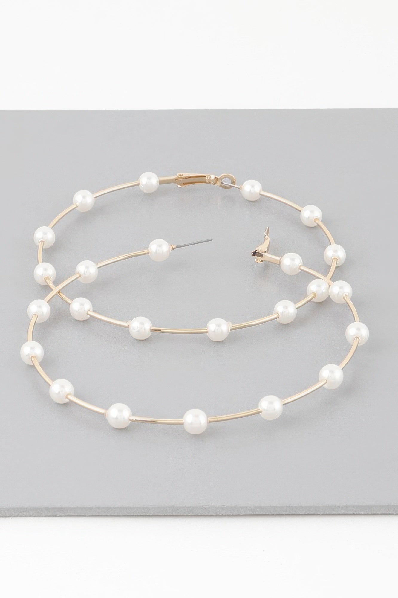 Oversized hoop earrings with cream faux pearls on gold-tone hoops