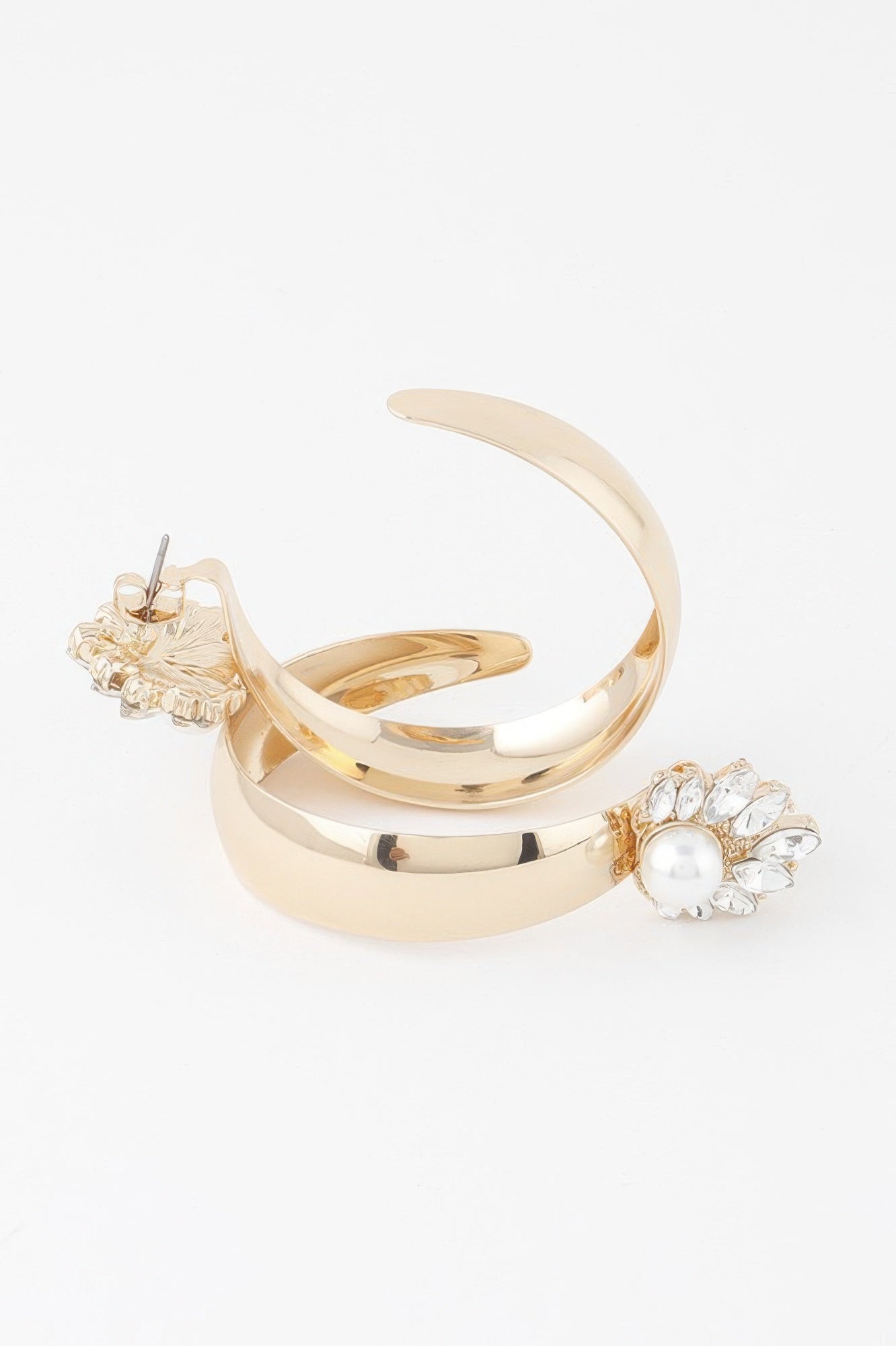 Gold-cream hoop earrings with pearl centerpiece and floral embellishment
